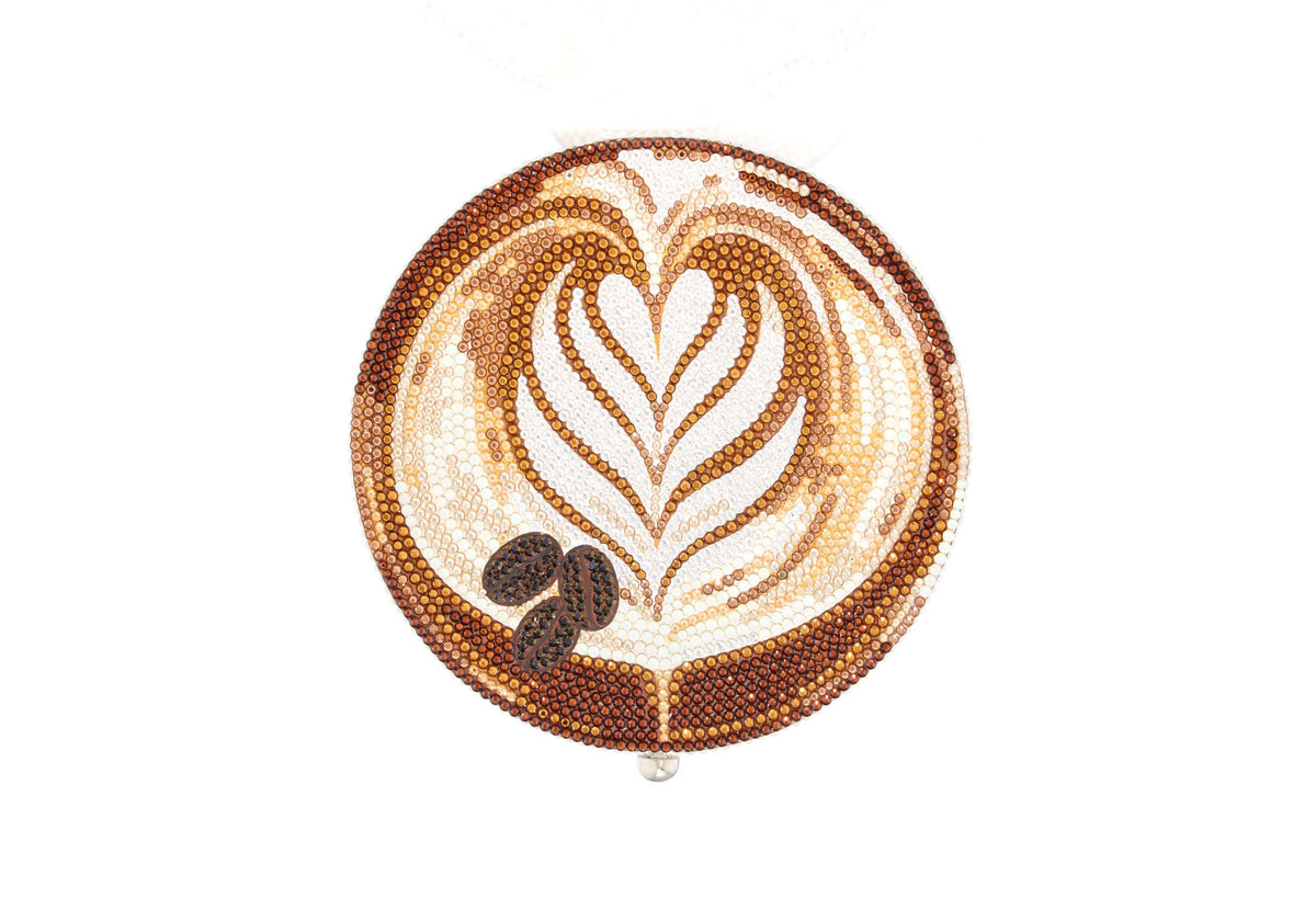 Crystal decorated clutch with coffee design and coffee beans on a white background