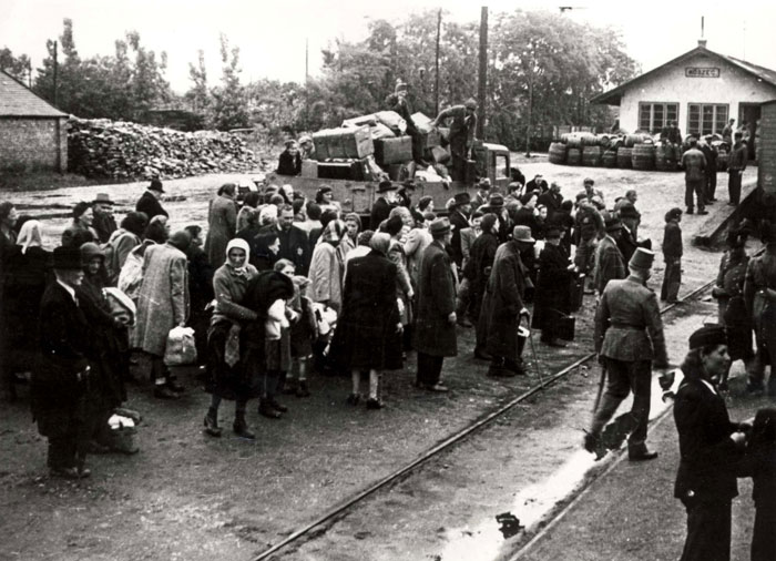 Crowds gathered at a railway station during the Nazi occupation