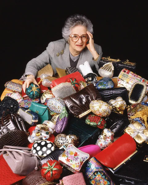 Judith Leiber surrounded by her handbag designs